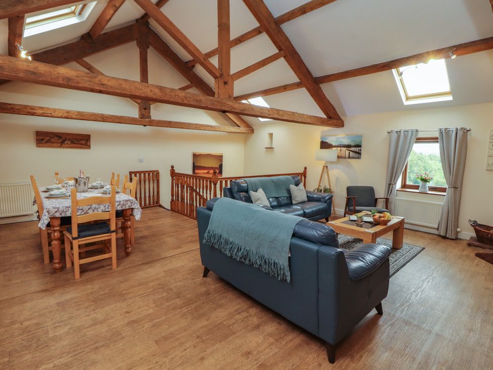 A living room with a dining area and seating at Hayloft Cottage Bolton Low Houses