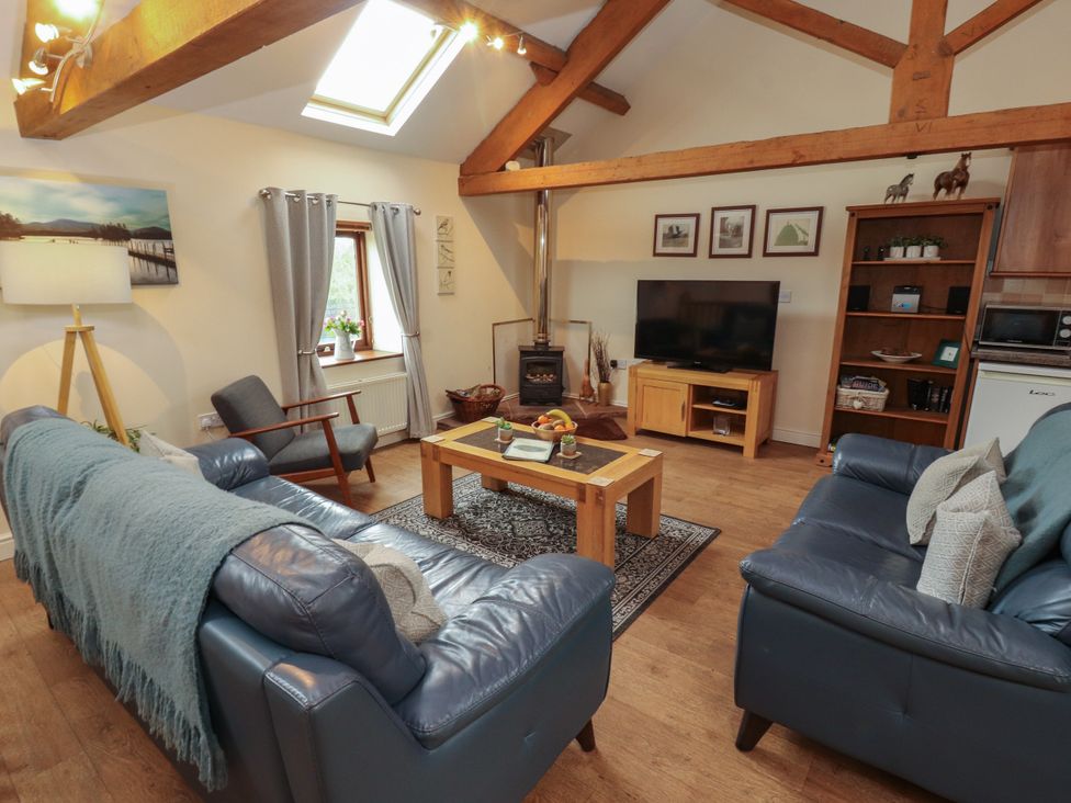 A living room with sofas and a coffee table at Hayloft Cottage Bolton Low Houses