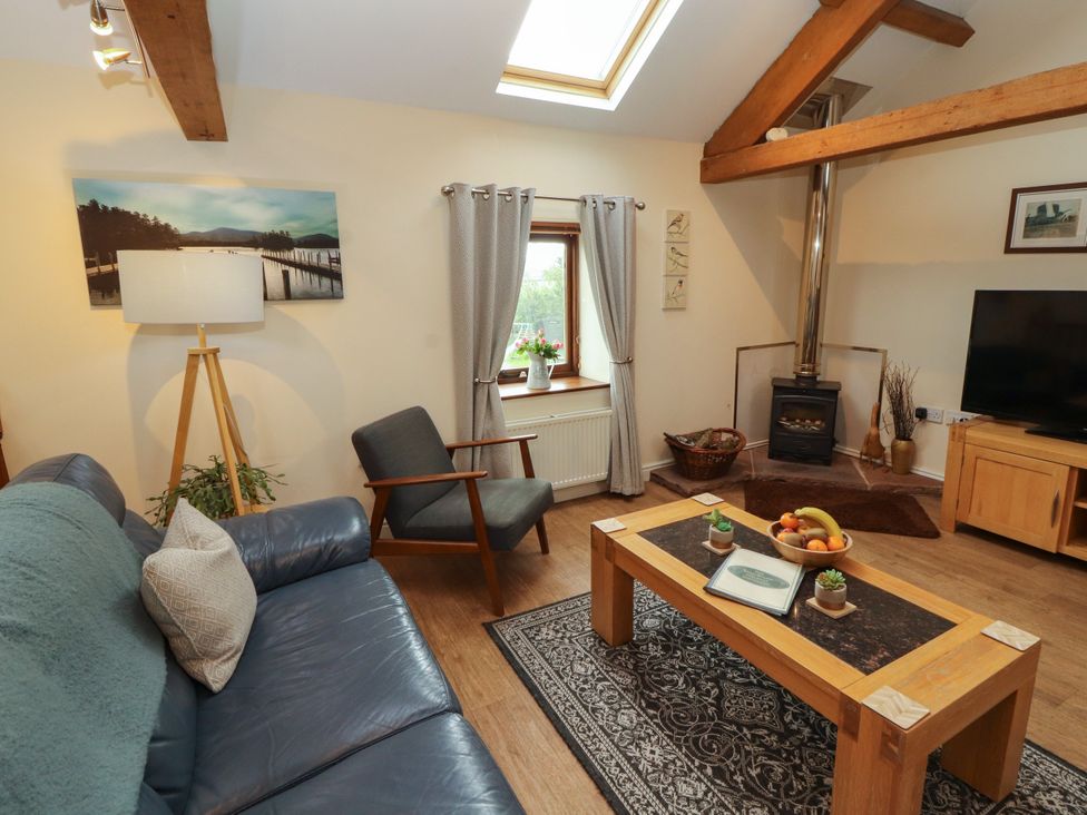 A living room with a sofa and coffee table at Hayloft Cottage in Bolton Low Houses