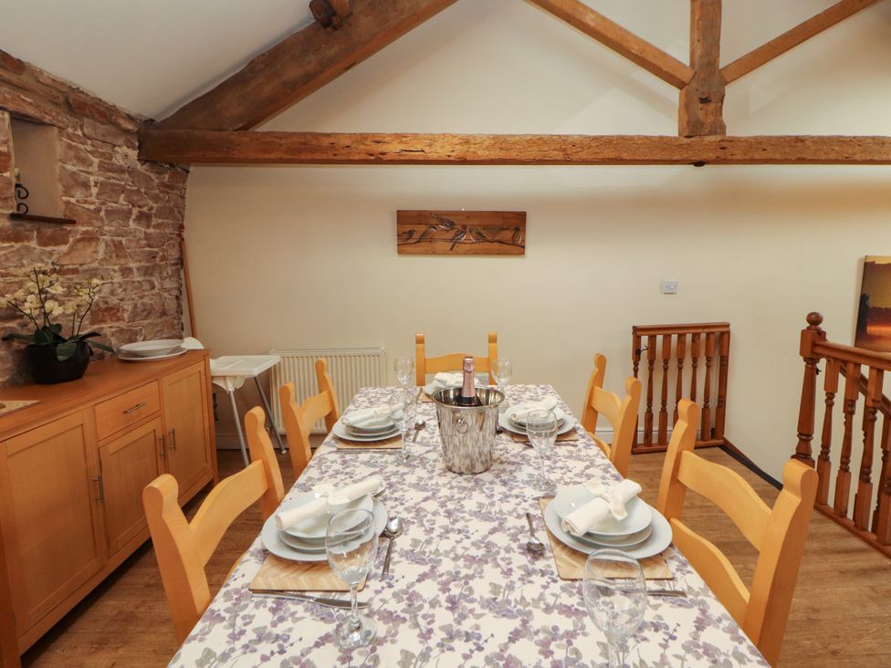 A dining room with a table set for meals at Hayloft Cottage Bolton Low Houses
