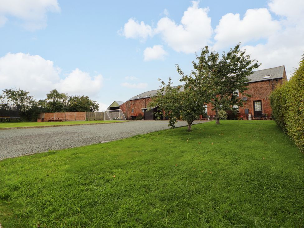 An outdoor view of a cottage with a gravel driveway at Hayloft Cottage in Bolton Low Houses