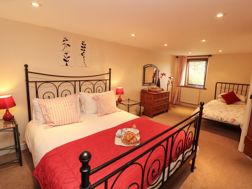 A bedroom with a double bed and a single bed at Horseshoe Cottage in Bolton Low Houses
