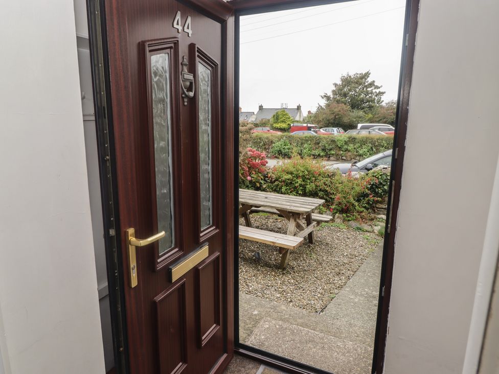 An entrance with a door and a bench outside at Garth Cottage Haverfordwest