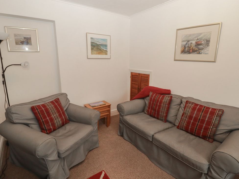 A sitting room with two sofas and a table at Garth Cottage in Haverfordwest