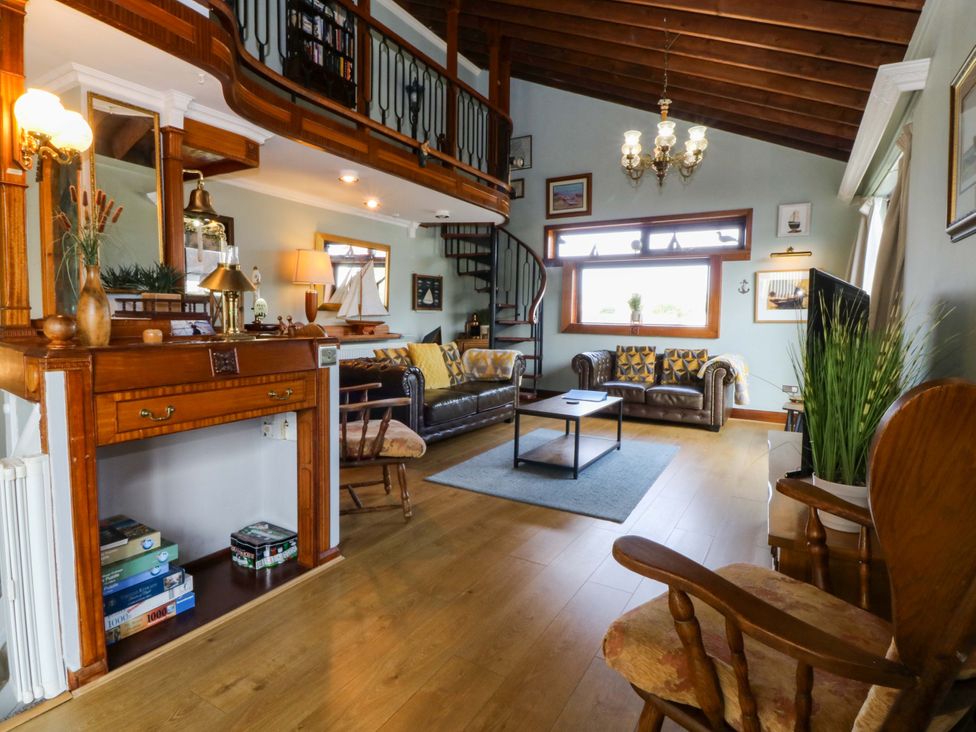A living room with a spiral staircase at Boathouse in Deganwy near Llandudno