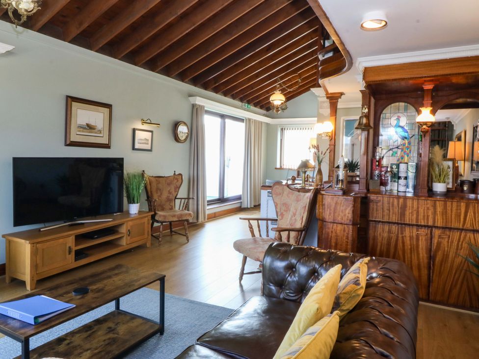 A living room with a television and sofa at Boathouse in Deganwy near Llandudno