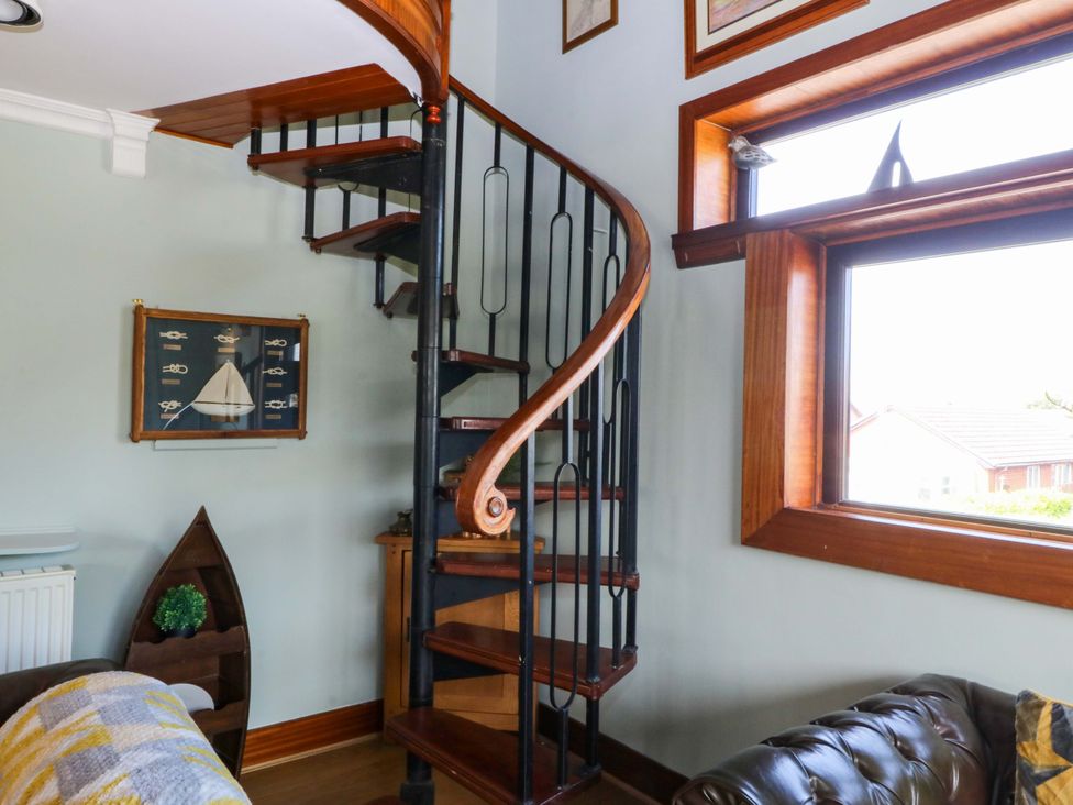A spiral staircase and window in a living room at Boathouse in Deganwy near Llandudno