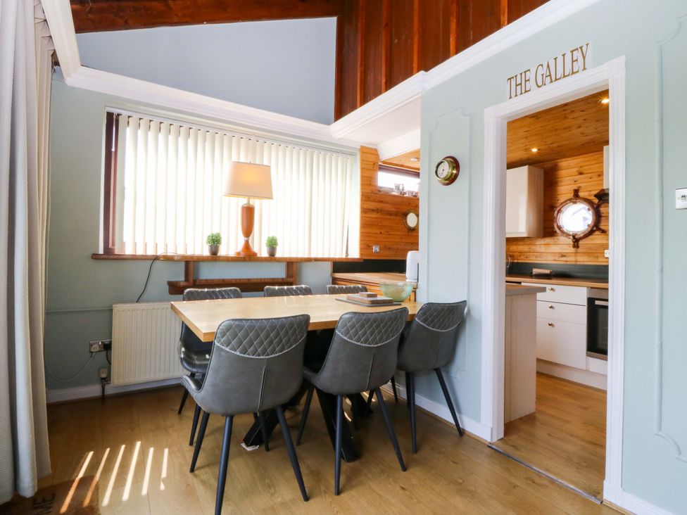 A dining area with a table and chairs at Boathouse in Deganwy near Llandudno