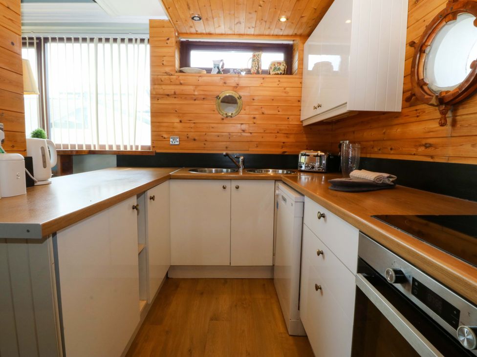 A kitchen with a countertop and appliances at Boathouse in Deganwy near Llandudno