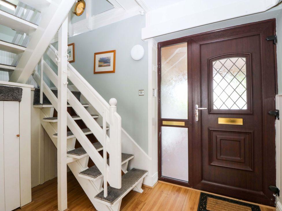 A hallway with stairs and a front door at Boathouse in Deganwy near Llandudno