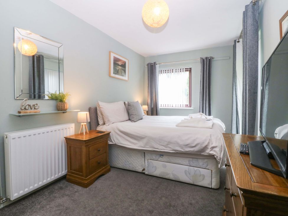 A bedroom with a bed and a television at Boathouse in Deganwy near Llandudno