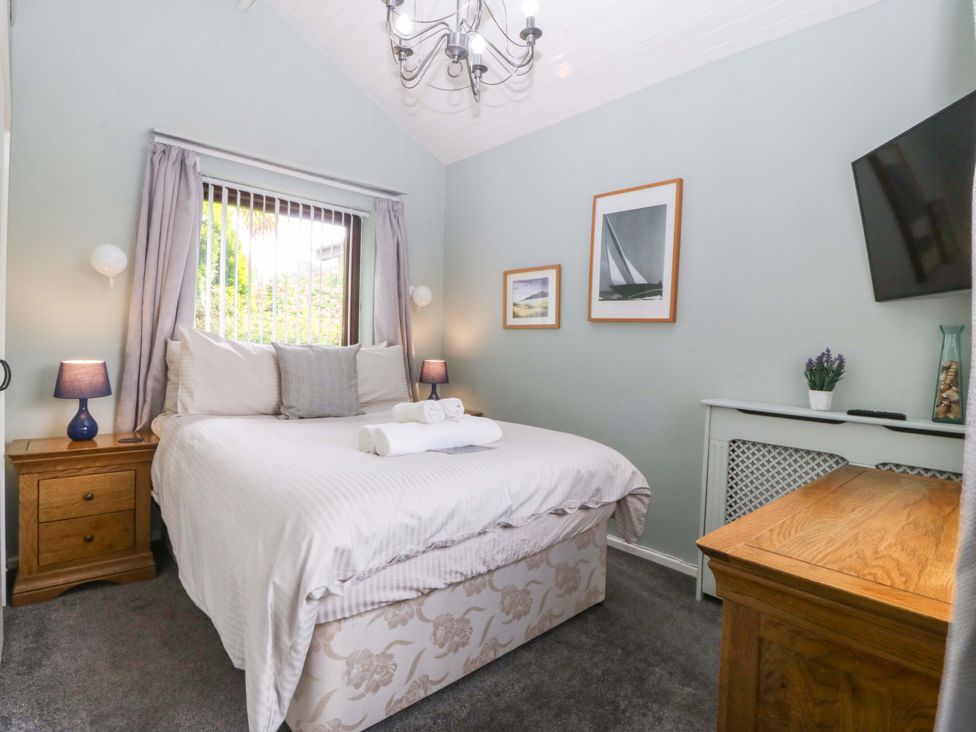 A bedroom with a bed and lamp at Boathouse in Deganwy near Llandudno
