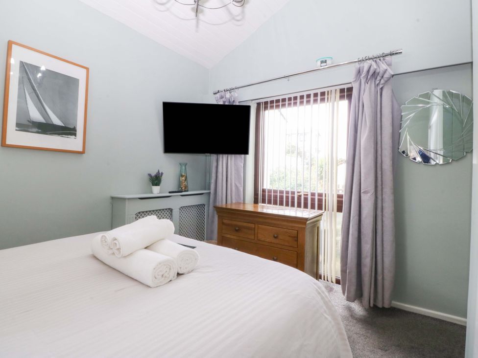 A bedroom with a bed and television at Boathouse in Deganwy near Llandudno