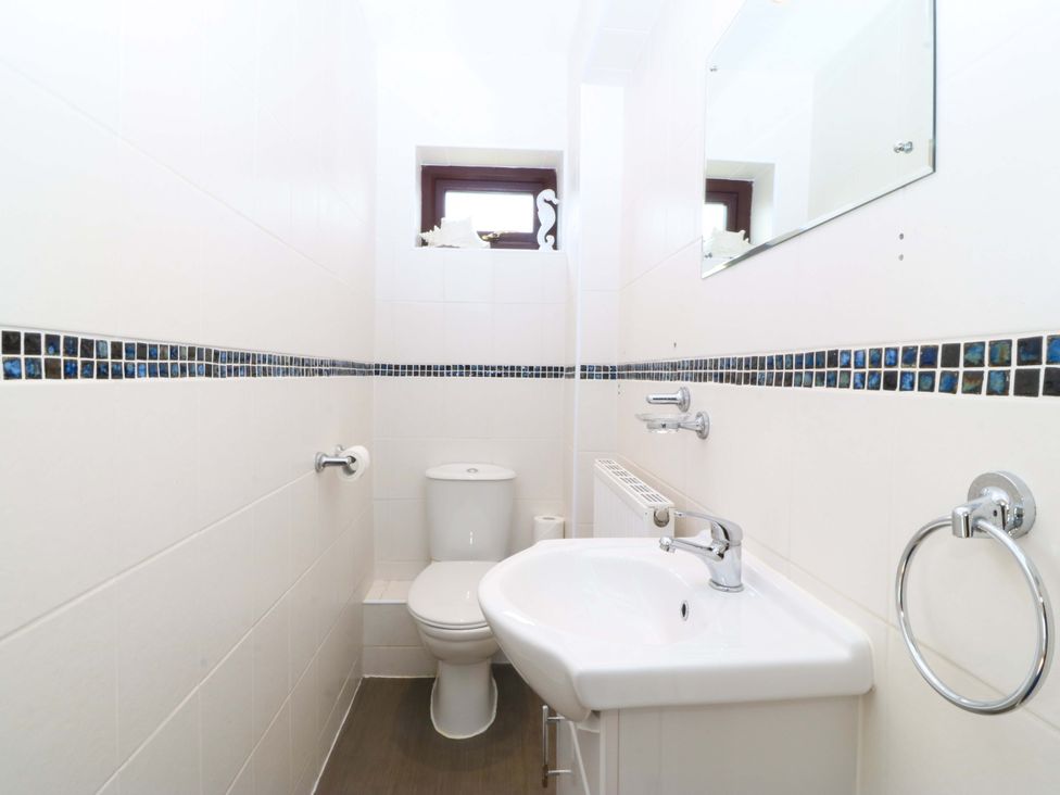 A bathroom with a toilet and sink at Boathouse in Deganwy near Llandudno