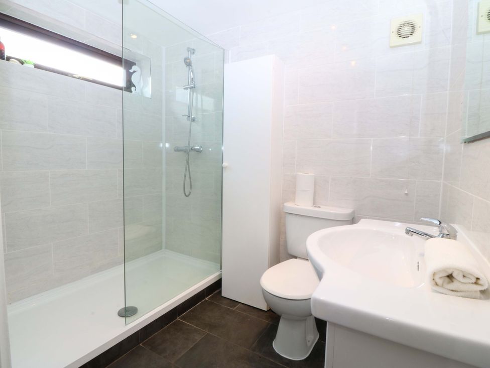 A bathroom with a shower, toilet, and sink at Boathouse in Deganwy near Llandudno