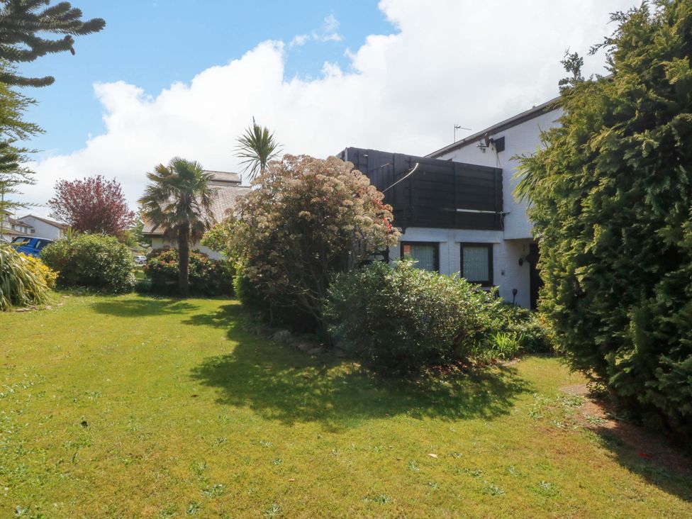A garden with shrubs and a building at Boathouse in Deganwy near Llandudno