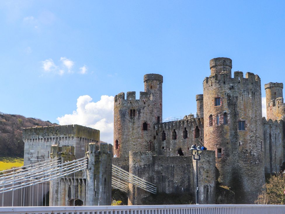 A view of a castle structure with towers and a bridge at Boathouse in Deganwy near Llandudno