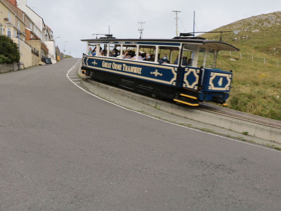A tram traveling uphill on the Great Orme Tramway in Deganwy near Llandudno