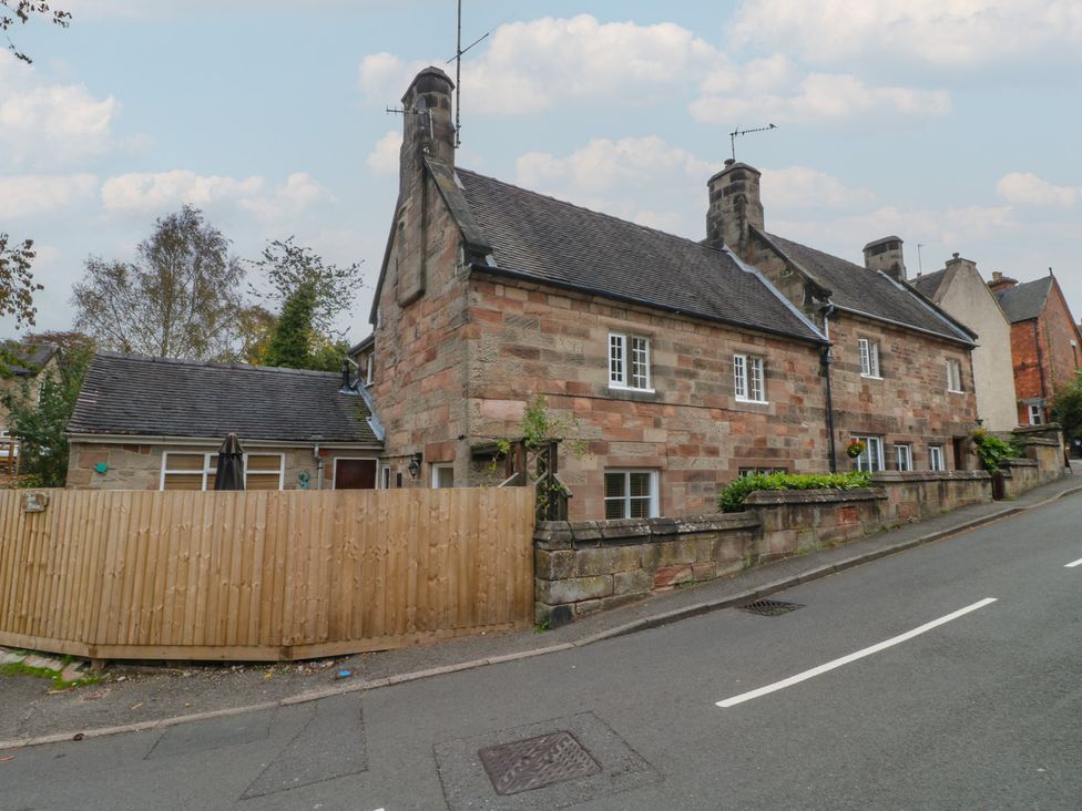 A house with a fence and trees on a street at Ash House in Alton near Alton Towers