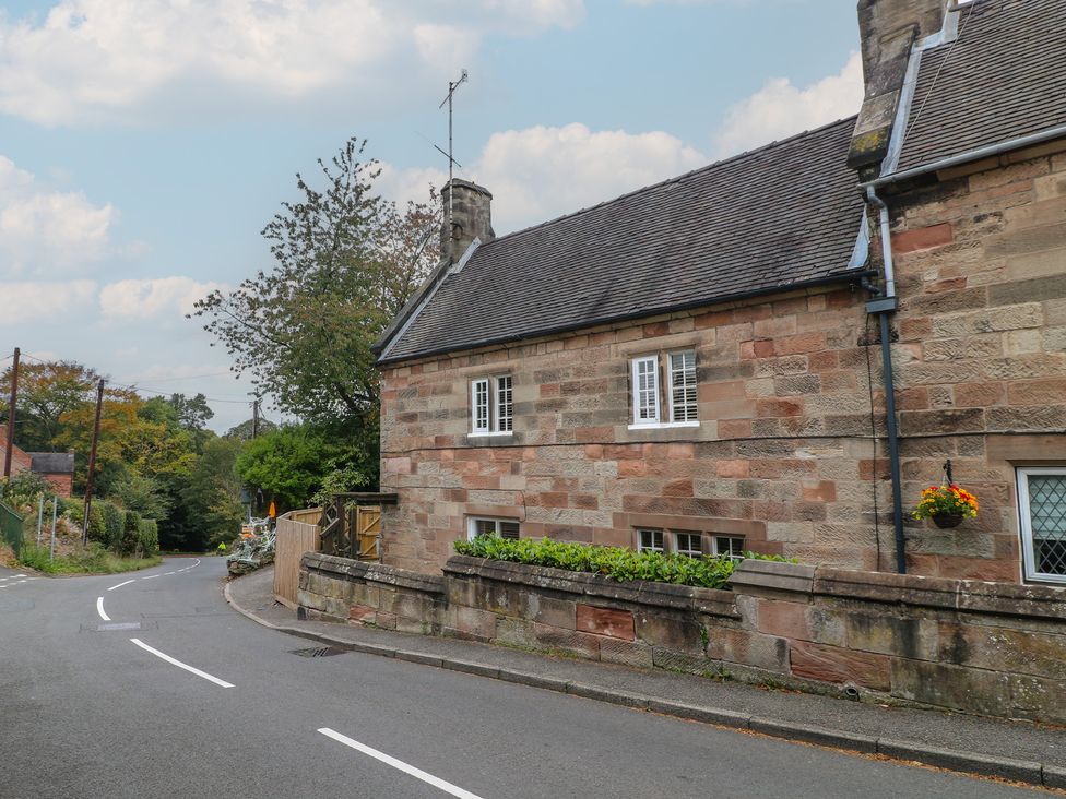 A stone house with windows and a flower pot outside at Ash House in Alton near Alton Towers