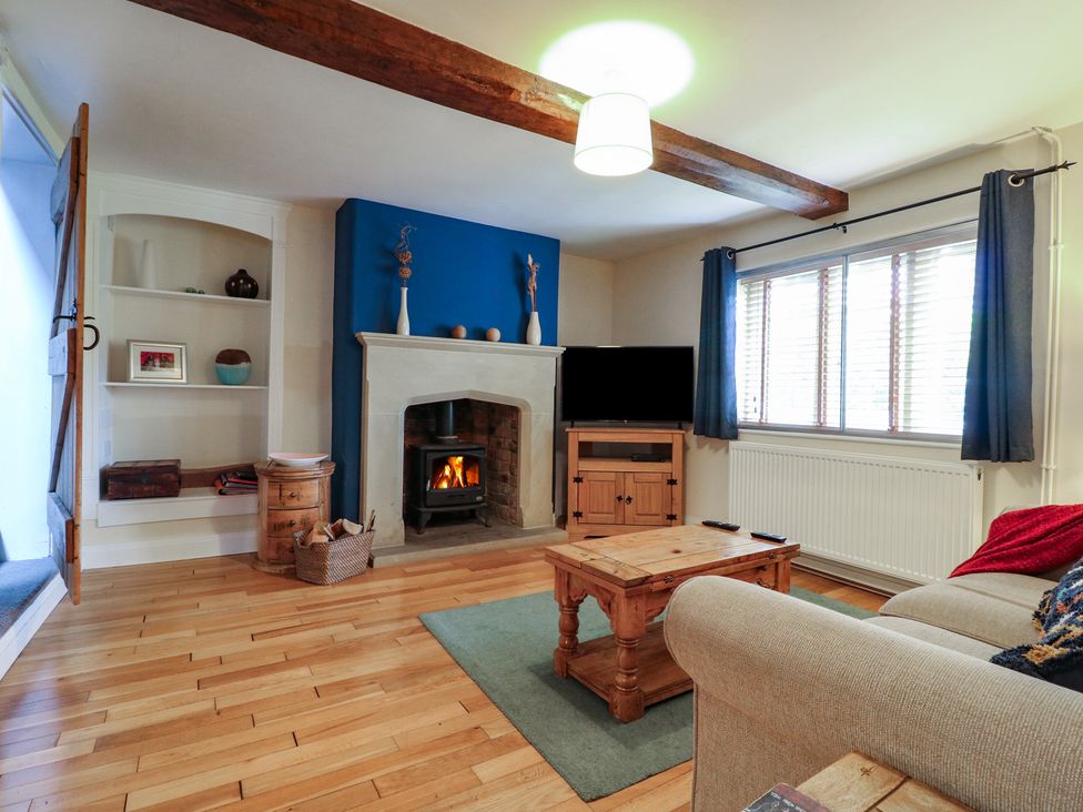 A living room with a fireplace and television at Ash House in Alton near Alton Towers