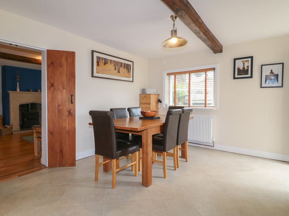 A dining room with a table and chairs at Ash House in Alton near Alton Towers