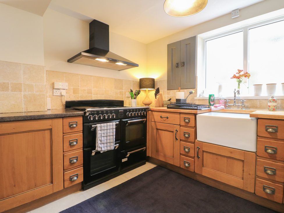 A kitchen with an oven and sink at Ash House in Alton near Alton Towers