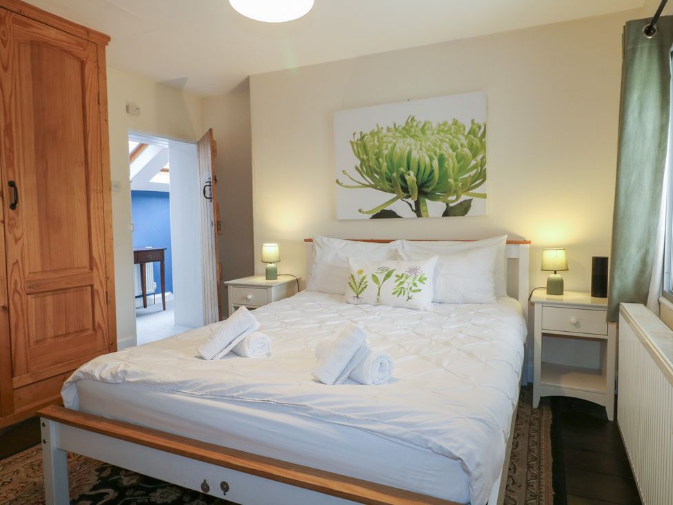 A bedroom with a bed and wardrobe at Ash House in Alton near Alton Towers