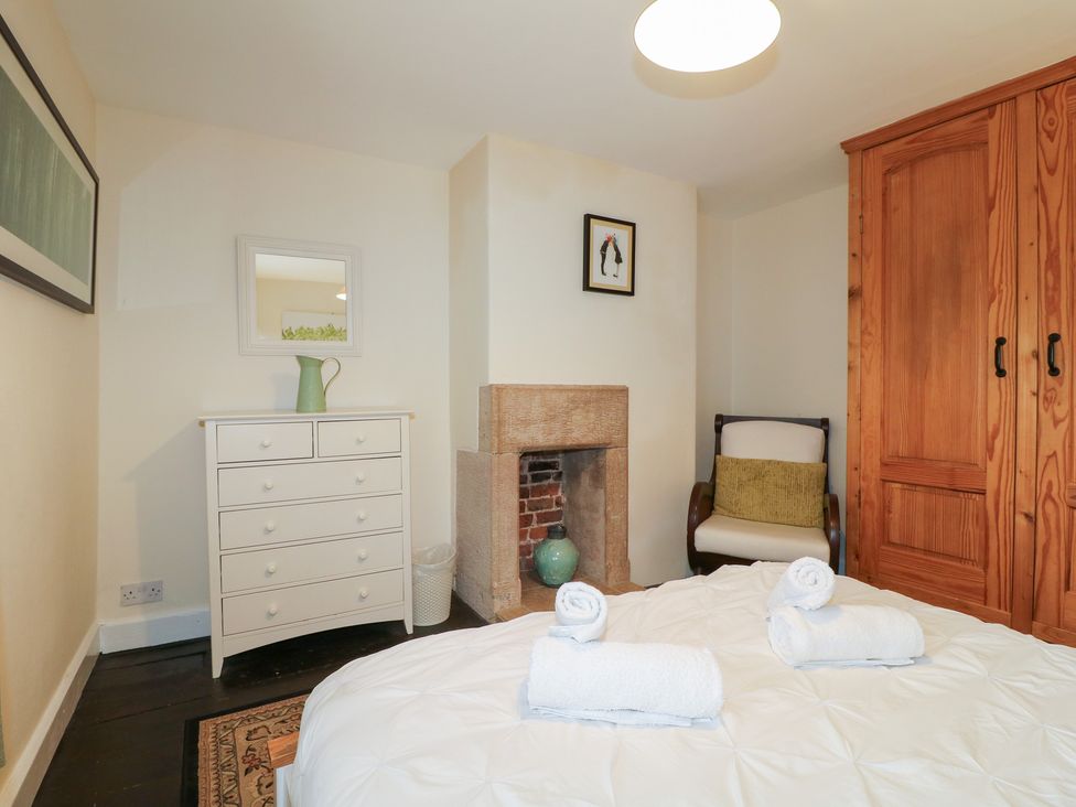 A bedroom with a bed and dresser at Ash House in Alton near Alton Towers