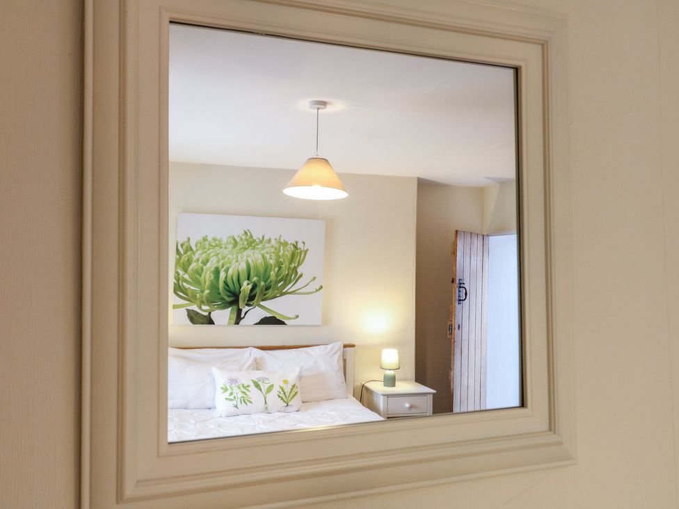 A bedroom with a bed and wall art at Ash House in Alton near Alton Towers