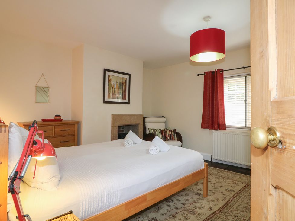 A bedroom with a bed and dresser at Ash House in Alton near Alton Towers