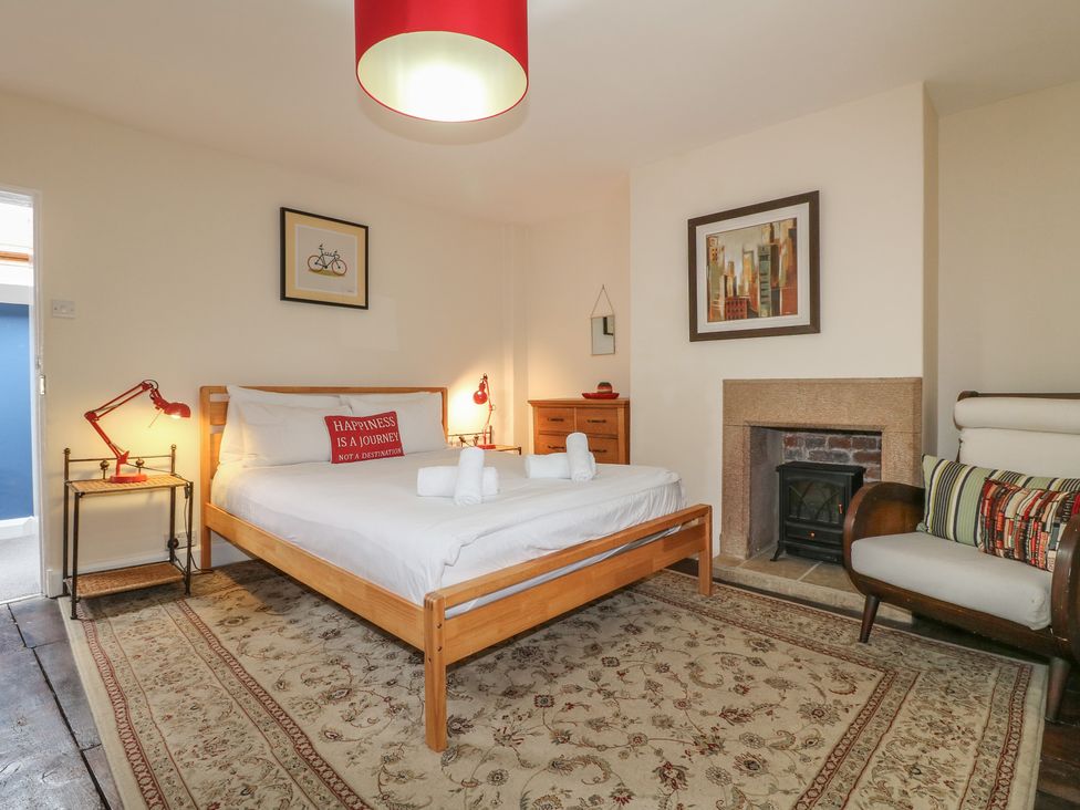 A bedroom with a bed and lamp at Ash House Alton near Alton Towers