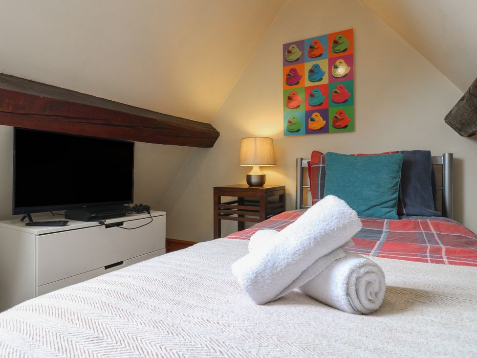 A bedroom with towels on the bed at Ash House in Alton near Alton Towers
