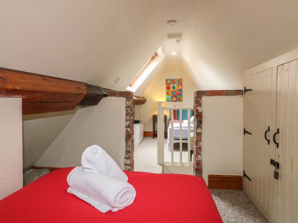 A bedroom with a bed and towels in Ash House Alton near Alton Towers
