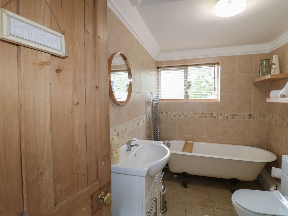 A bathroom with a bathtub and sink at Ash House in Alton near Alton Towers
