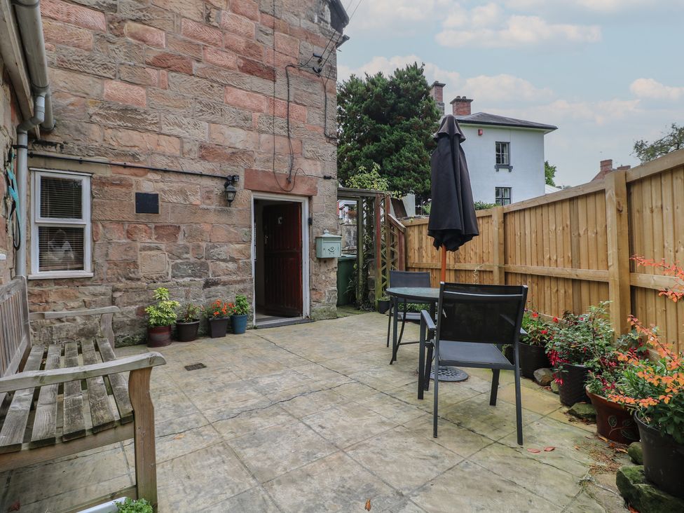 An outdoor space with a bench and table at Ash House in Alton near Alton Towers