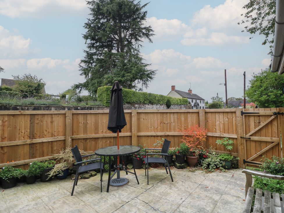 A garden with a table and chairs at Ash House in Alton near Alton Towers