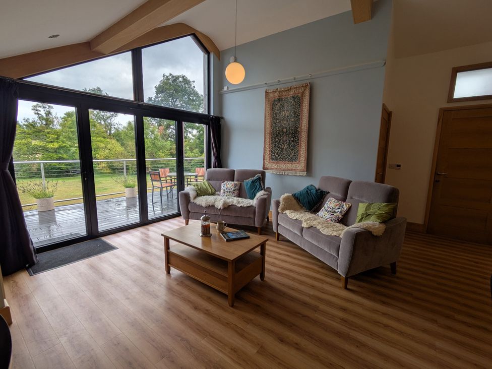 A living room with seating and a coffee table at Cointree in Sturminster Newton