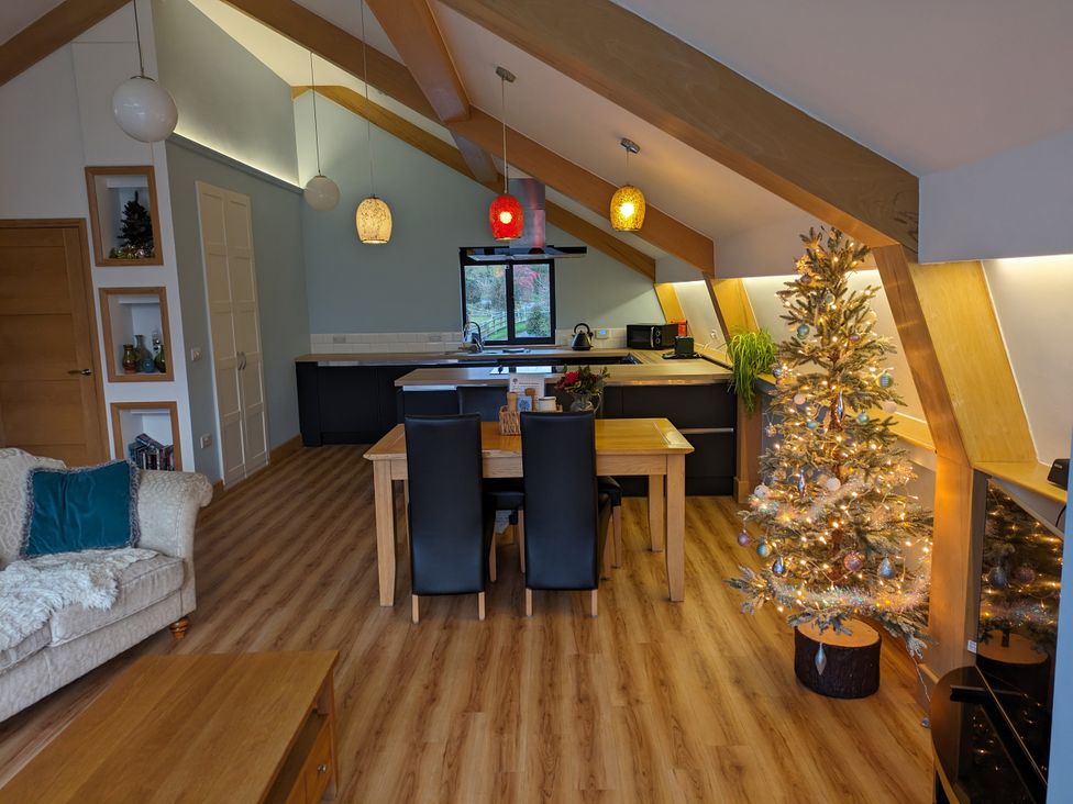 A kitchen with a dining table and Christmas tree at Cointree in Sturminster Newton