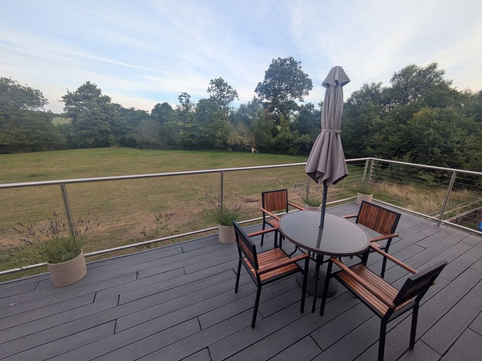 An outdoor patio with a table and chairs at Cointree in Sturminster Newton