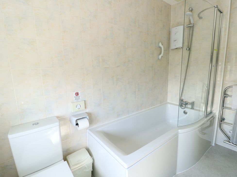 A bathroom with a bathtub and shower at Bryn y Don in Benllech