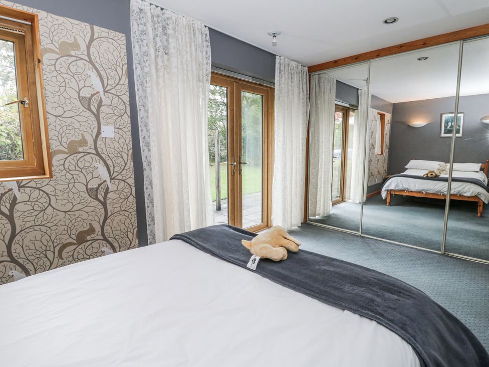 A bedroom with a view of the garden at Geryllan Rhandirmwyn near Llandovery