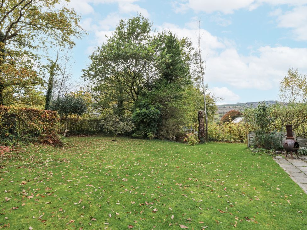 A garden with grass and trees at Geryllan in Rhandirmwyn near Llandovery