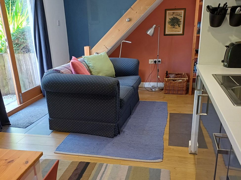 A living room with a sofa and lamp at The Sidings in Wirksworth