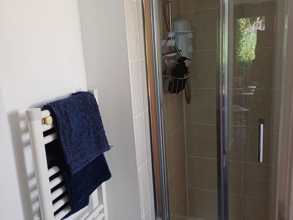 A bathroom with towels and a shower at The Sidings in Wirksworth