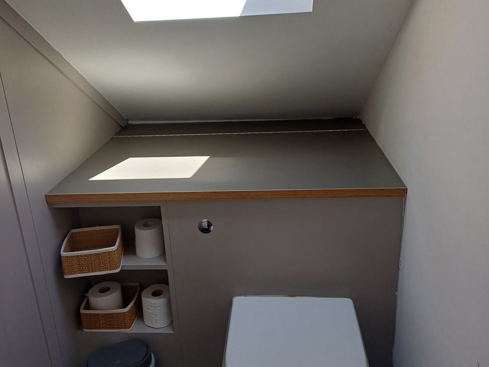 A bathroom with shelves and toilet paper at The Sidings in Wirksworth