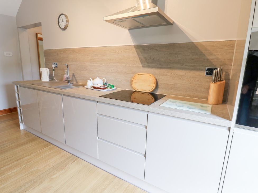 A kitchen with a sink and cooking area at The Hayloft in Alston