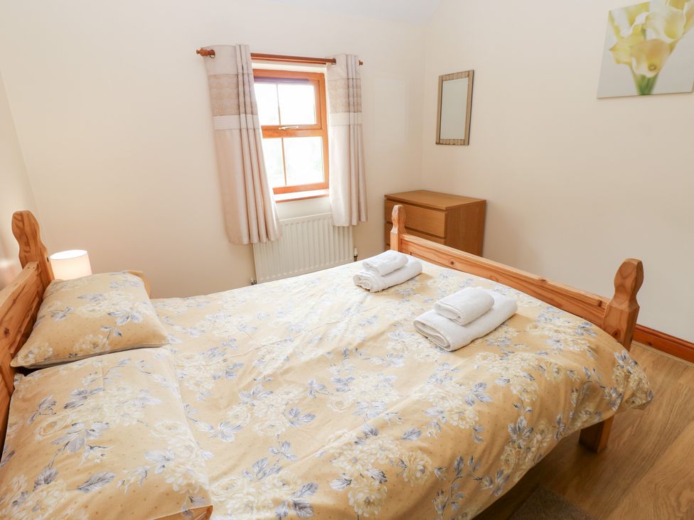 A bedroom with a bed and towels on it at The Hayloft in Alston