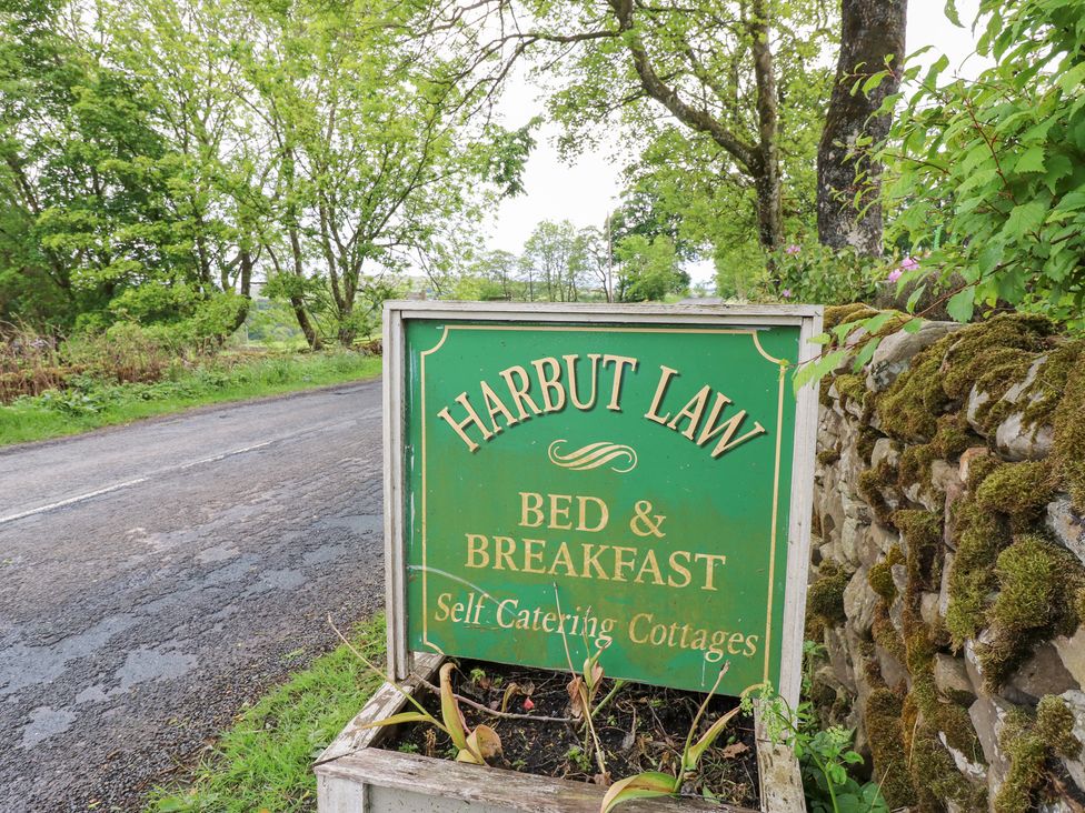 A sign for Harbut Law Bed & Breakfast and Self Catering Cottages near a road at The Hayloft in Alston