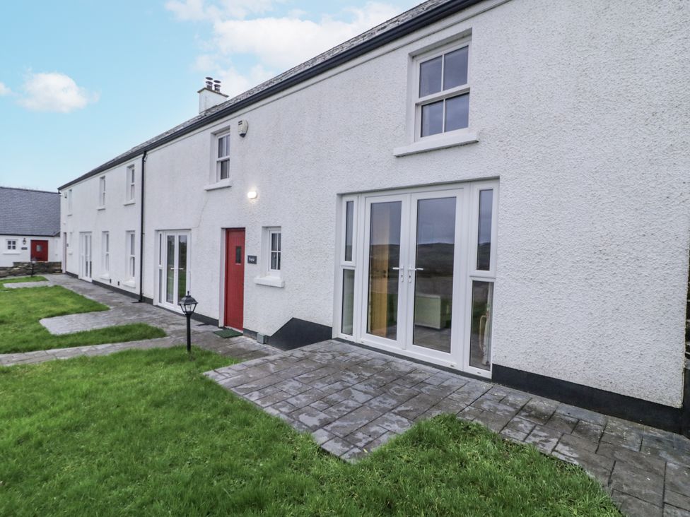 An outdoor view of a house with a patio and garden at Foyle Cottage near Strabane